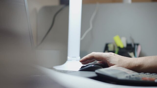 Office Worker Using Computer Mouse at Desk