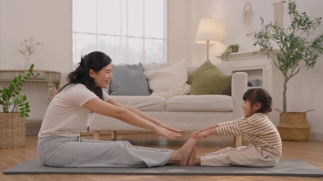 Woman and Child Stretching Together on Exercise Mat in Bright Living Room, Family Bonding Through Wellness, Fitness, Yoga, and Healthy Home Exercise Session