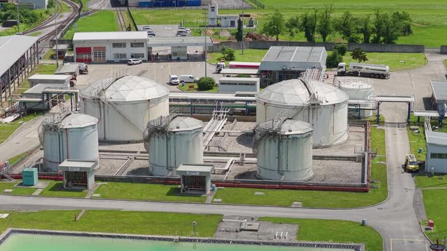 This aerial view shows a large oil storage facility with multiple tanks.