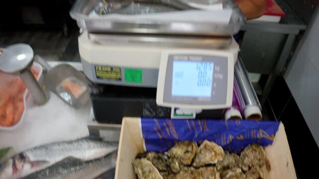 Golden sea bream and other fresh fish displaying on ice at a market counter, ready for sale and healthy cooking