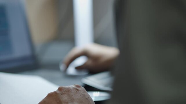Hand Holding Magnifying Glass While Inspecting Office Document