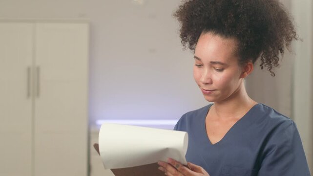 Diligent Black Woman With Natural Hair In Scrubs Reviews Important Medical Documents
