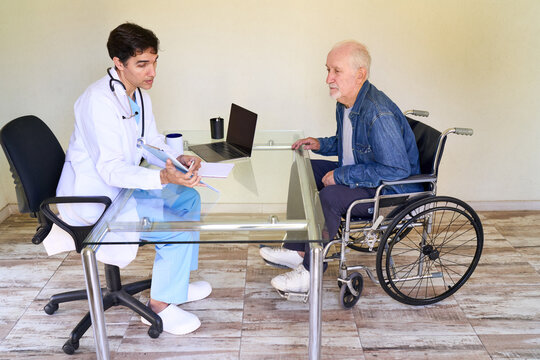 Home healthcare consultation, doctor house call with senior man in wheelchair, medical care and patient support at home