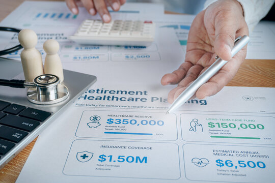 Business professional pointing to retirement healthcare planning document with stethoscope, calculator, wooden doll family figures, medical insurance, elderly care fund and financial health concept