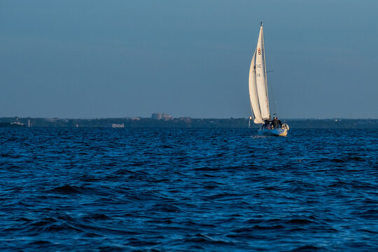 White sailing yacht boat luxury cruise on blue sea water at sunny day.
