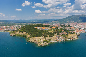Fototapeta premium Aerial drone view of Ohrid in North Macedonia during summer, featuring historic old town, UNESCO heritage landmarks, harbor and crystal clear Lake Ohrid surrounded by scenic landscape