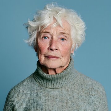 Elderly woman with white hair looking at camera