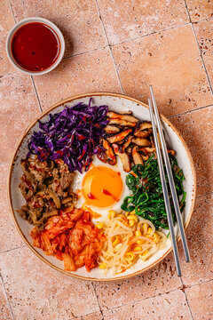 Bibimbap with colorful vegetables, beef, and egg