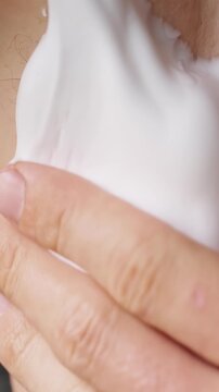 Hand Applies White Cream to Underarm Skin in Closeup, Personal Hygiene and Skincare Routine Supporting Daily Body Care Vertical video.