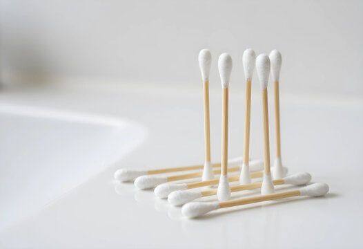 Sustainable hygiene and eco friendly personal care, bamboo cotton swabs on a white bathroom counter