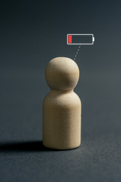 Low energy person with low battery icon representing fatigue, stress and declining productivity