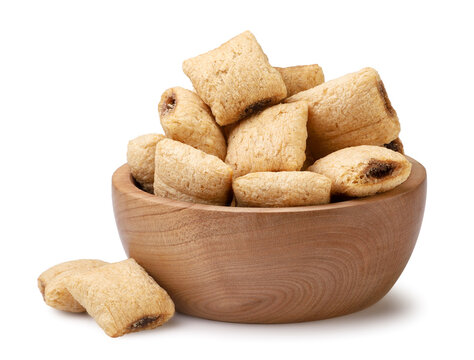 Cereal pads in a wooden bowl close-up on a white. Isolated