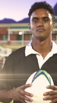Animation of glowing lights over diverse rugby players in sports stadium