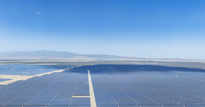 Aerial View of Vast Solar Power Plant in Desert Under Blue Sky