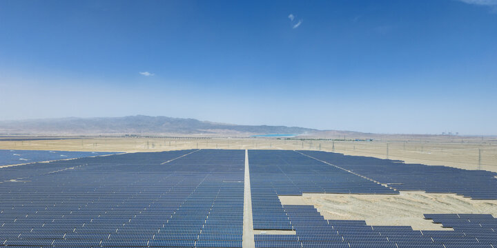 Aerial View of Large Solar Photovoltaic Power Station in Gobi Desert with Mountains