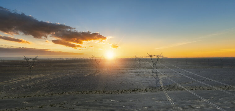 Aerial View of Power Grid Transmission Towers in Gobi Desert at Sunset