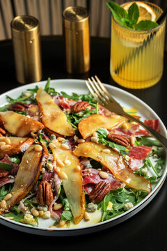 Salad with Pear, Arugula, Jamon, Blue Cheese and Blueberry, Delicious Fresh Salad Appetizer on Bright Background