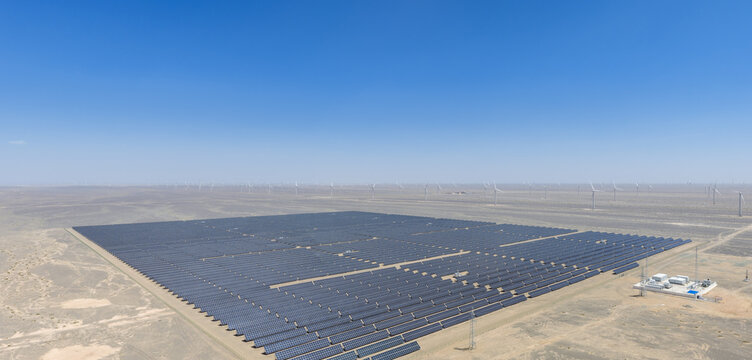 Aerial View of Solar Farm and Wind Turbines in Desert
