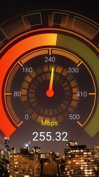 Animation of orange speedometer over night cityscape