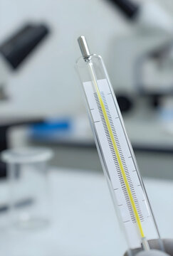 Medical research and laboratory testing, close up of a thermometer in a science lab with equipment