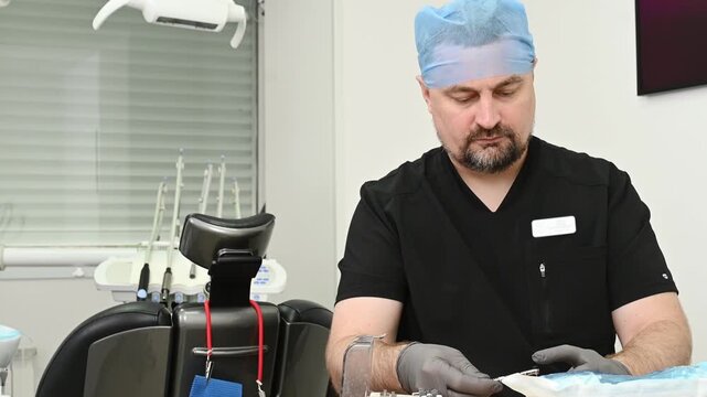 Dentist examines dental implant model in clinic, checking implant positioning and prosthetic construction for precise treatment planning and dental restoration.