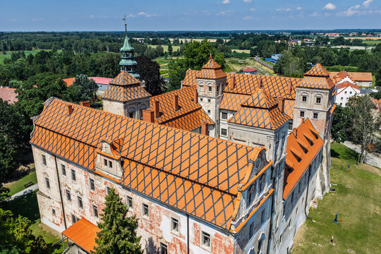 Aerial view of the Ducal Castle in Niemodlin, Poland with market square, old town, colorful buildings and streets in the historic city center on a sunny day. Castle and square in Niemodlin, Poland