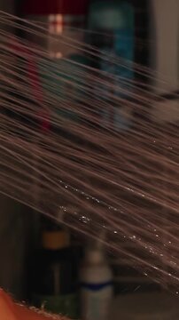 Adult Man Rinses Hairy Chest With a Handheld Shower in a Tiled Bathroom, Close View Supporting Daily Hygiene and Wellbeing Vertical video.
