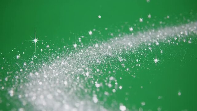 Sparkling dust trail moving across a green screen background with subtle camera parallax