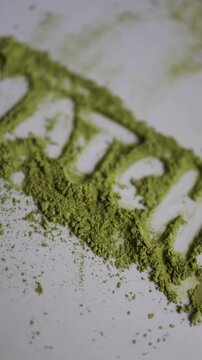 Vertical screen macro view of high quality matcha powder showing rich green color fine texture and fresh appearance as premium Japanese green tea powder for healthy drink