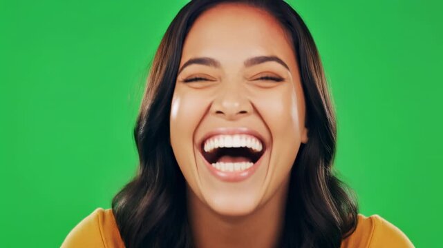 Young Woman Expressing Joyful Laughter with Dynamic Facial Expressions Against a Chroma Key Background