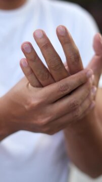 Closeup man holds his wrist. hand injury, feeling pain. Health care and medical concept. and those with a family history of degenerative knuckles.	