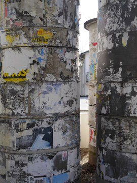 Two old, rusted metal cylinders covered in graffiti
