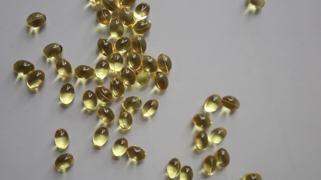 Healthy lifestyle background with omega oil softgels across a bright surface illustrating dietary choices essential nutrients daily self care and everyday wellness habits