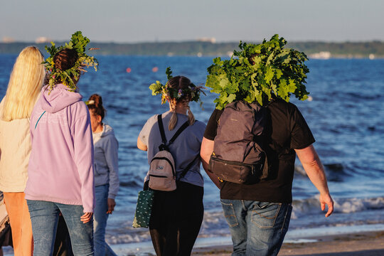 Ligo evening, people wearing traditional Jani wreaths on Kauguri beach in Jurmala Latvia