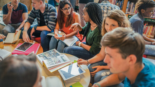 Diverse students studying together library