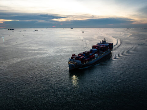 Large Container Cargo Ship Sailing Through The Calm Sea During Sunset In Si Racha Chon Buri Thailand For Global Logistics And International Freight Distribution
