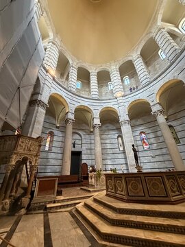 Interior of Pisa Baptistery with Romanesque arches and marble columns, Italy
