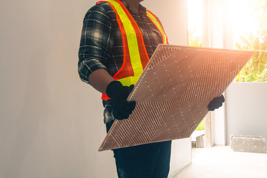 The tile cutter is being used for laying tiles.