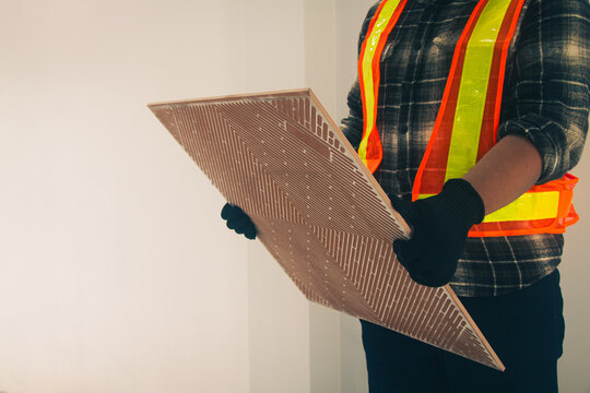 The tile cutter is being used for laying tiles.