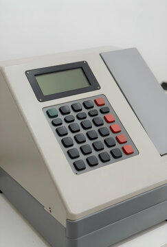 Vintage calculator or cash register machine, retro technology and accounting equipment, isolated on a white background