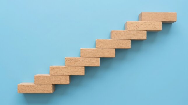 Wooden blocks arranged as a staircase on blue background