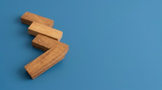 Wooden blocks arranged in a zigzag pattern on blue background