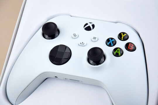 The white Xbox controller on the beige background.