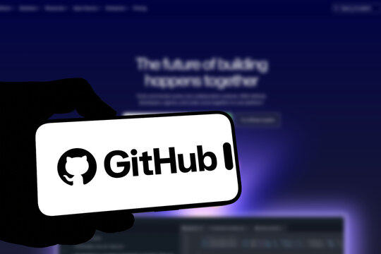 Kiel, Germany - 08-19-2026: Smartphone displaying US code hosting platform GitHub logo in front of companys webpage