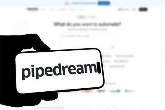 Kiel, Germany - 08-19-2026: Smartphone displaying US developer integration platform Pipedream logo in front of companys webpage