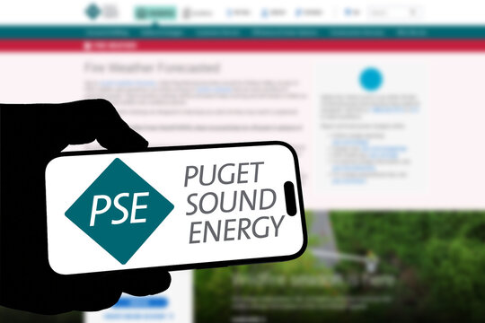 Kiel, Germany - 08-19-2026: Smartphone displaying US energy utility company PSE logo in front of companys webpage
