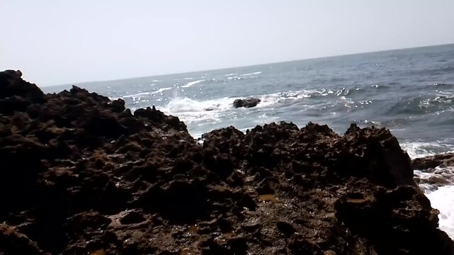 Dark Coastal Rock Ridge Overlooking Ocean Waves