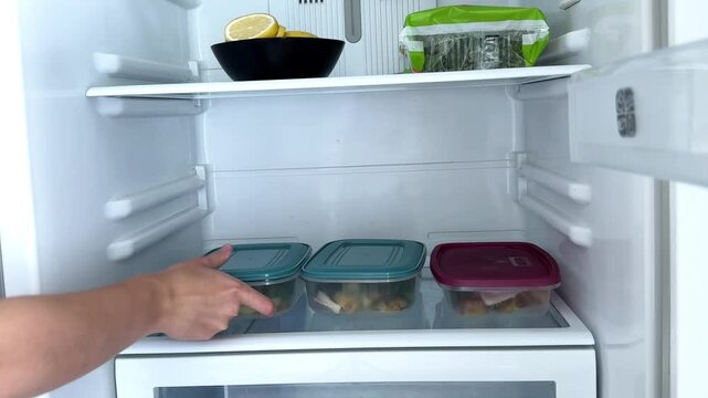 Putting Meal Prep Boxes into Refrigerator