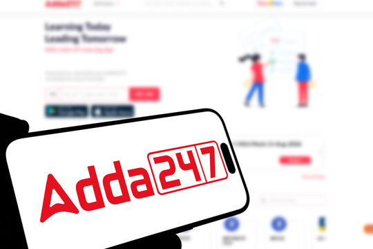 Kiel, Germany - 08-19-2026: Smartphone displaying Indian education technology company Adda247 logo in front of companys webpage