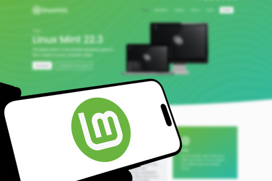 Kiel, Germany - 08-19-2026: Smartphone displaying Irish operating system project Linux Mint logo in front of companys webpage